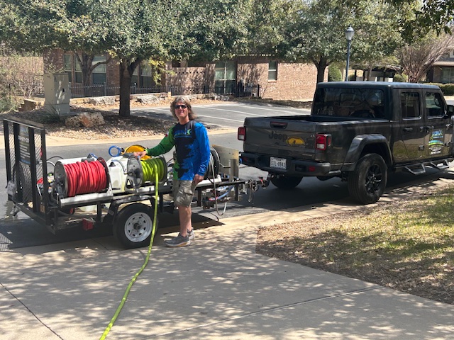 Duane Miller with his arms resting on the Gen X Pressure Washing Trailer